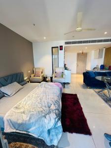 a bedroom with a bed and a living room with a couch at Luxury Studios Key 7 in Gurgaon +12 photos