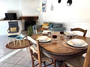 a wooden table with chairs and a dining room at gite du navech in Camjac