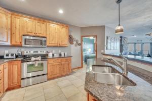 a kitchen with wooden cabinets and stainless steel appliances at Bridges Bay Resort Coronado Building 302 in Arnolds Park