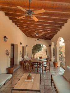 a patio with a ceiling fan and a table and chairs at Viñas De Cafayate Wine Resort in Cafayate