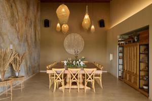 a dining room with a wooden table and chairs at Tau House in Guatapé