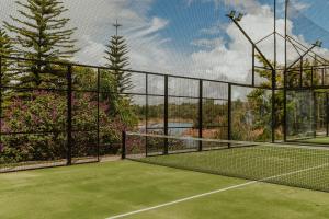 a tennis court with a net on top of it at Tau House in Guatapé