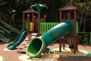 a playground with a slide and chairs at Tau House in Guatapé +40 photos