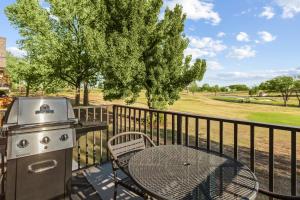 a grill and table on a balcony with a table and chair at WorldMark Grand Lake in Monkey Island