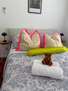 a teddy bear sitting on a pillow on a bed at Irina's bnb in Auckland
