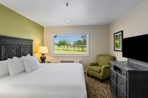 a bedroom with a large bed and a television at WorldMark Grand Lake in Monkey Island