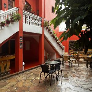 a patio with tables and chairs in a building at Econunay Hostels in Arequipa