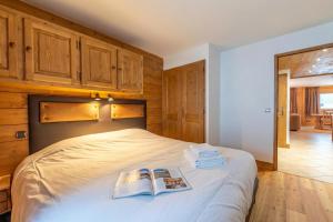 a bedroom with a bed with two books on it at Residence Bec in Chamonix