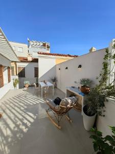 a patio with chairs and a table on a balcony at Old Town Suites Muradie in Vlorë