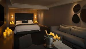 a hotel room with a bed and a couch at SoHo Hotel Toronto in Toronto
