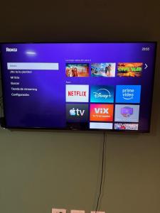 a flat screen tv hanging on a wall at Dpto en la costa in Villa María