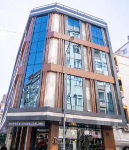 a tall building with glass windows on a street at Zirvesta Otel in Istanbul