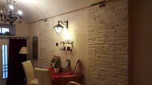 a dining room with a table and a stone wall at Hotel Romantik Eger in Eger