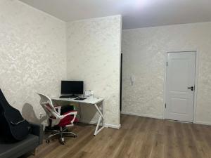 an office with a desk with a computer and chairs at Sunrise Guesthouse UB in Ulaanbaatar