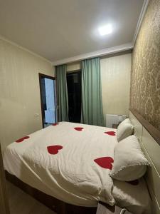 a bedroom with a bed with red hearts on it at City View Apartments At Dadiani St in Tbilisi City