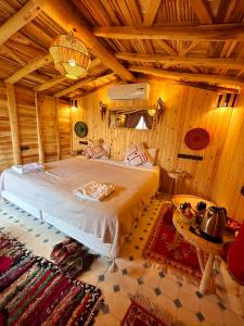 a bedroom with a bed in a wooden room at Atlas Prestige in Imlil