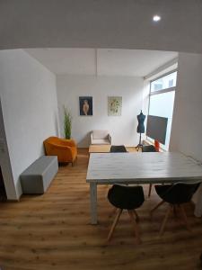 a living room with a table and chairs at CUBE 5 New in Bad Saulgau