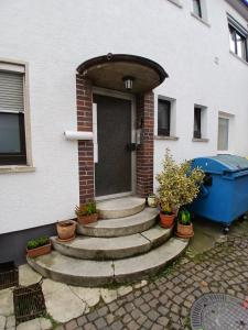 a front door of a house with potted plants at CUBE 5 New in Bad Saulgau +4 photos