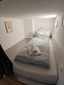a small bedroom with a bed with towels on it at CUBE 5 New in Bad Saulgau