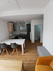 a kitchen and living room with a white table and chairs at CUBE 5 New in Bad Saulgau