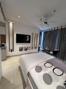 a bedroom with a large bed with a flat screen tv at Zebra Luxe Loft Studio with patio in Gurgaon