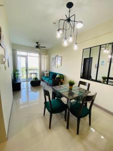 a dining room and living room with a table and chairs at Threeos Cabana in Boracay