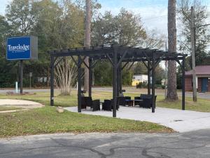 a pavilion with tables and chairs in a park at Travelodge by Wyndham Bainbridge in Bainbridge