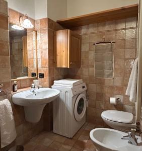 a bathroom with a washing machine and a sink at Casa Mezzavalle in Pelugo +51 photos