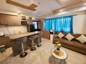 a kitchen and living room with a couch and a table at 2 Bedroom Corner in Davao City