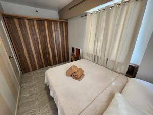 two towels sitting on a bed in a bedroom at 2 Bedroom Corner in Davao City