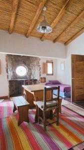 a room with a table and two beds at ETERNO SOL Loft Andino in Humahuaca