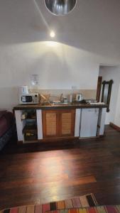 a kitchen with a sink and a counter top at ETERNO SOL Loft Andino in Humahuaca +26 photos