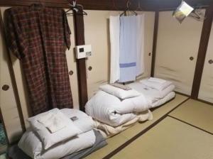 a room with three stacks of white towels at q 2603 Onomichi Tea Celemony Villa in Onomichi