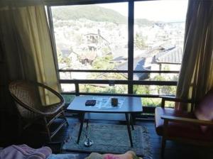 a room with a table in front of a window at q 2603 Onomichi Tea Celemony Villa in Onomichi