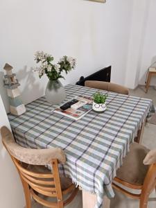 a table with a vase of flowers on top of it at Adamovic in Pirot