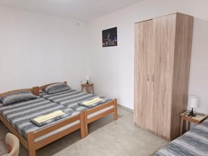 a bedroom with a bed and a wooden cabinet at Adamovic in Pirot
