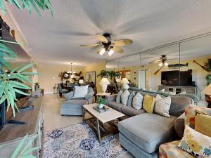 a living room with a couch and a table at Island Echos #3K in Fort Walton Beach