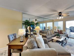 a living room with a couch and a table at Island Echos #3K in Fort Walton Beach