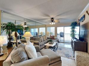 a living room with a couch and a tv at Island Echos #3K in Fort Walton Beach