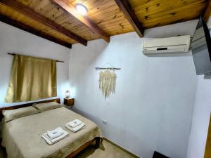a bedroom with a bed with two towels on it at Mi sueño apart en Mercedes Corrientes!!! in Mercedes
