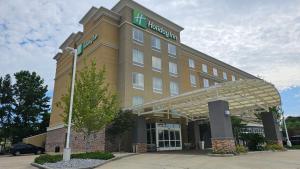 a hotel building with a sign on top of it at Holiday Inn Covington by IHG in Covington