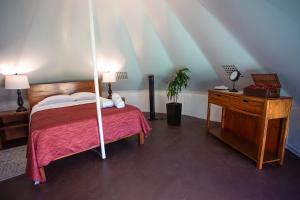 a bedroom with a canopy bed and a wooden desk at Hameki in Homún +46 photos
