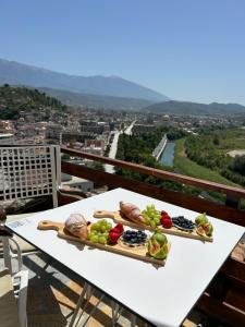 two plates of food on a table on a balcony at Veranda Guest House in Berat
