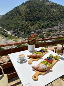 a table with food and a view of a mountain at Veranda Guest House in Berat +6 photos