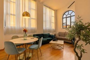a living room with a table and a couch at The Queens House in Bellinzona +38 photos