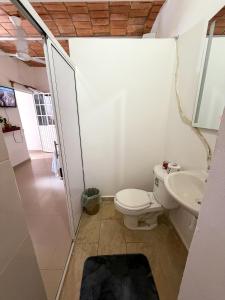 a bathroom with a toilet and a sink at Casa Baluana vive Sayulita a un paso de todo in Sayulita