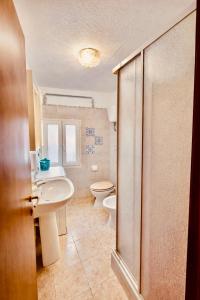 a bathroom with a sink and a toilet at Mediterranea Apartment in Agrigento +23 photos