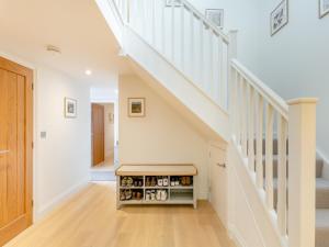 a staircase with a bench under the stairs at Haybale Barn in Chatton +38 photos