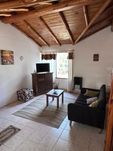 a living room with a couch and a table at Las Palomas in Trevelín