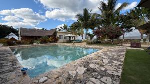a swimming pool in front of a house at Hameki in Homún